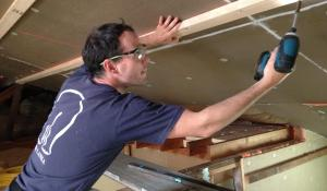 Man installing attic materials